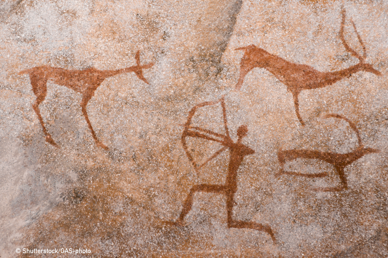 An image of an ancient man's hunting on the wall of a cave. ancient world history.