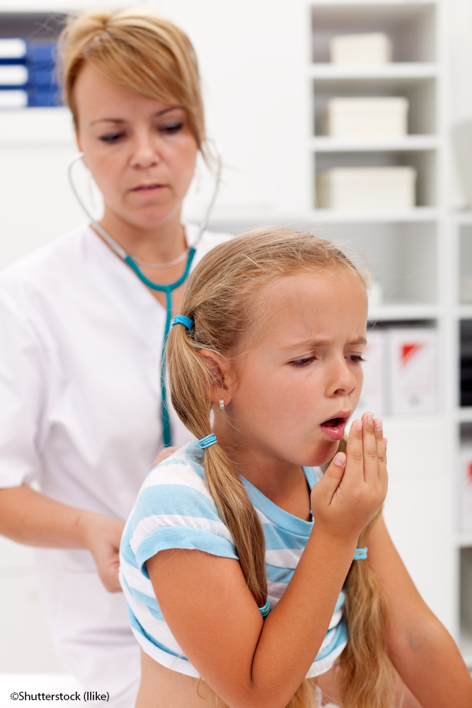 Coughing little girl on health checkup at the doctor